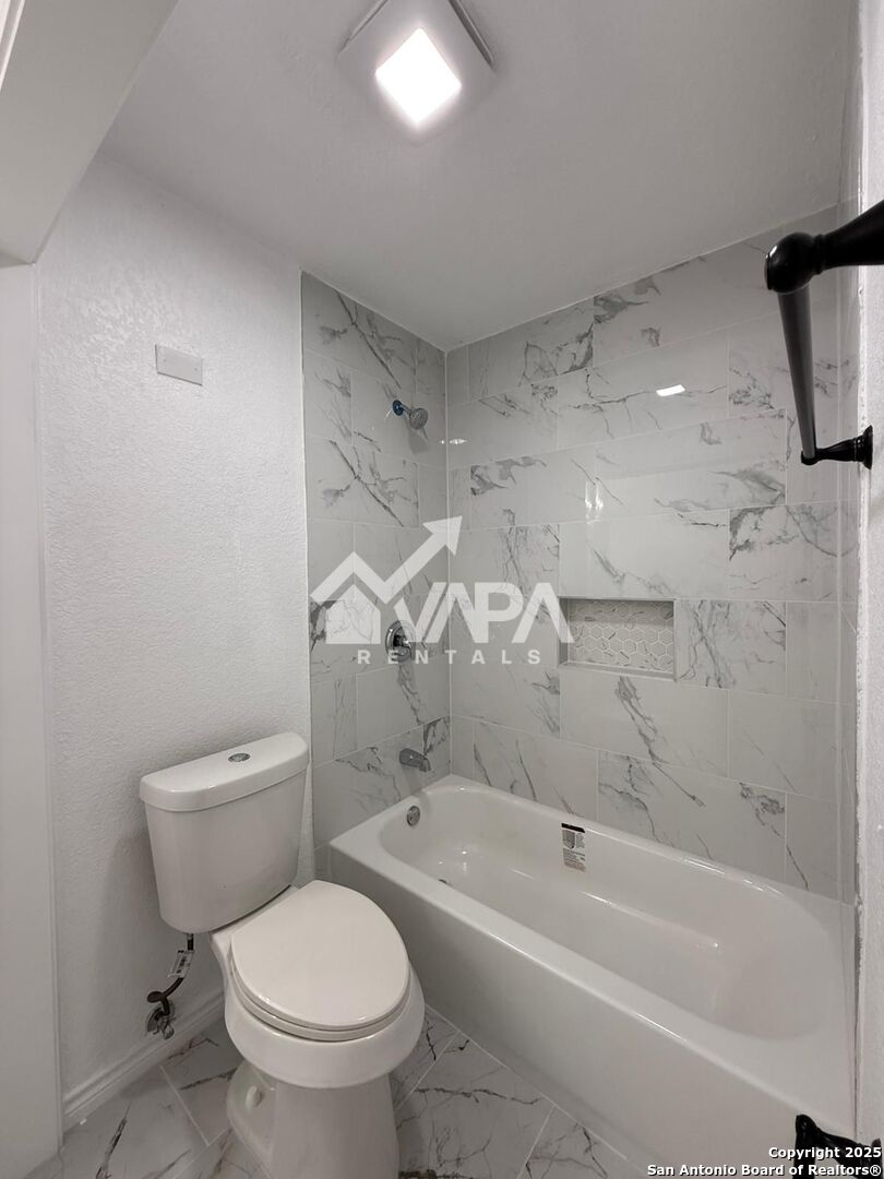 7422 Pipe Spring Street San Antonio, TX 78238 - Photo 3 of 13 a bath room with a toilet and a bath tub