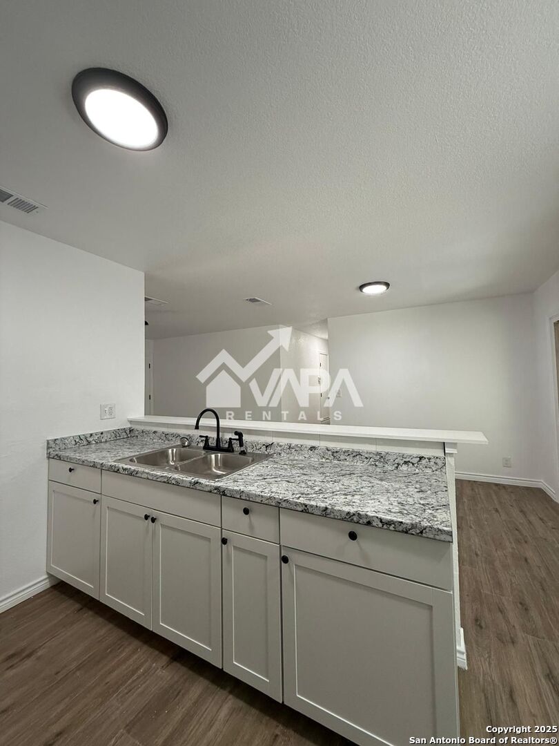 7422 Pipe Spring Street San Antonio, TX 78238 - Photo 8 of 13 a bathroom with a granite countertop sink and a mirror
