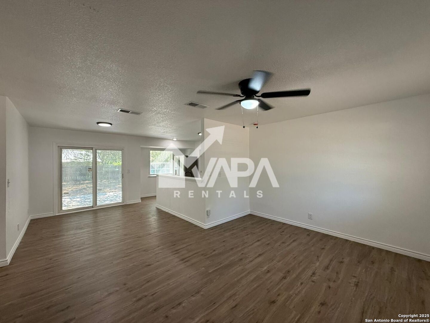 7422 Pipe Spring Street San Antonio, TX 78238 - Photo 9 of 13 a view of an empty room with wooden floor and a window