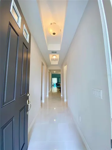 a view of a hallway with wooden shelves
