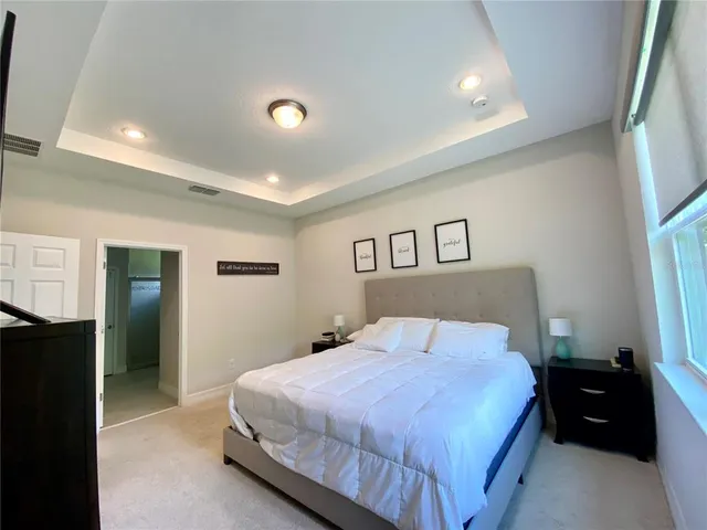 a bedroom with a bed and a large mirror