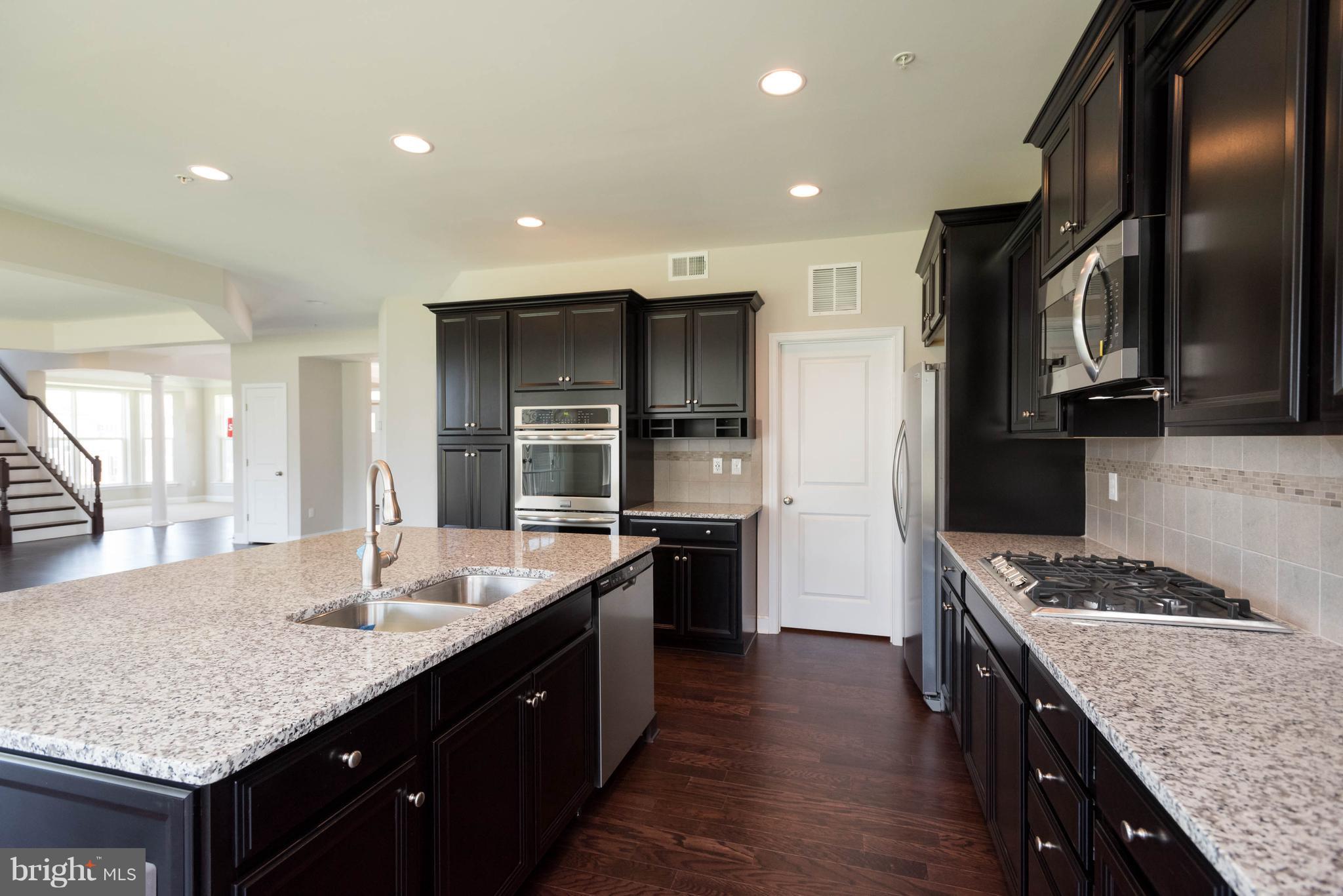 9763 Powder Hall Road Perry Hall, MD 21128 - Photo 12 of 30 a kitchen with stainless steel appliances granite countertop a sink stove and refrigerator