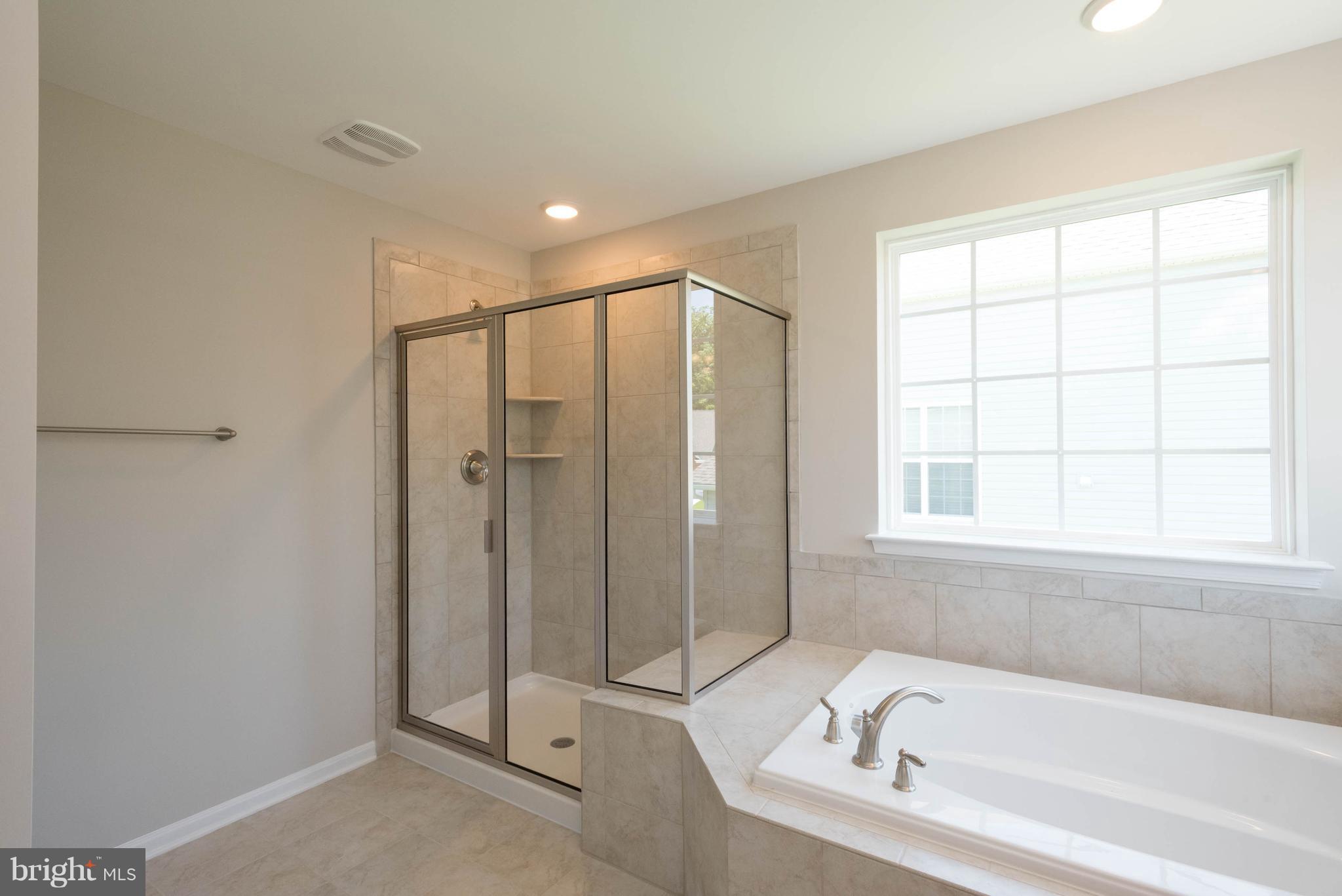 9763 Powder Hall Road Perry Hall, MD 21128 - Photo 21 of 30 a bathroom with a bathtub and a shower