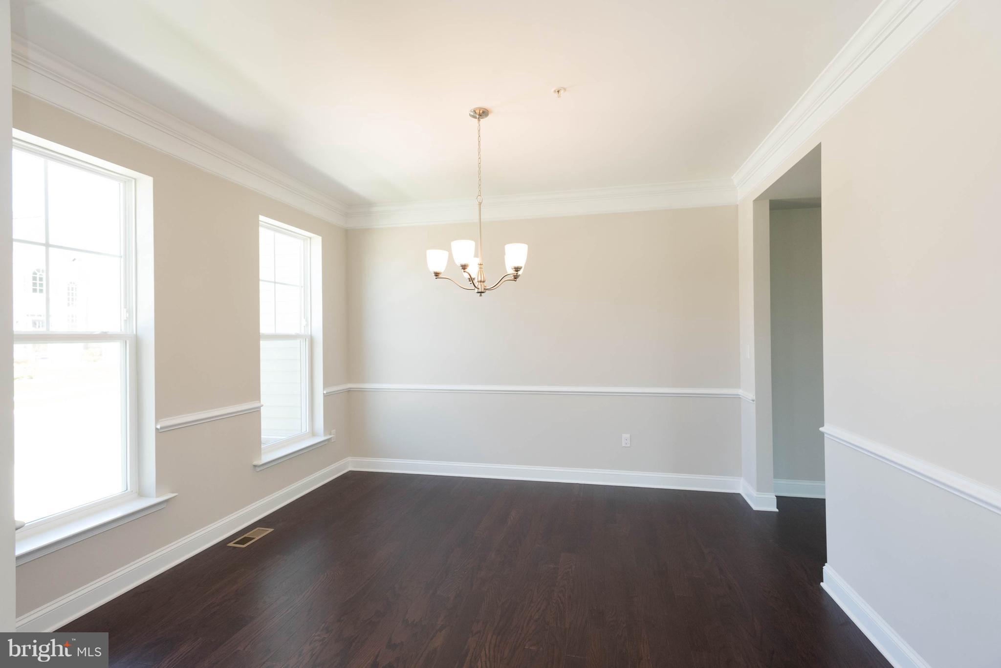 9763 Powder Hall Road Perry Hall, MD 21128 - Photo 6 of 30 an empty room with wooden floor windows and entrance