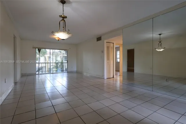 a view of an empty room with glass door
