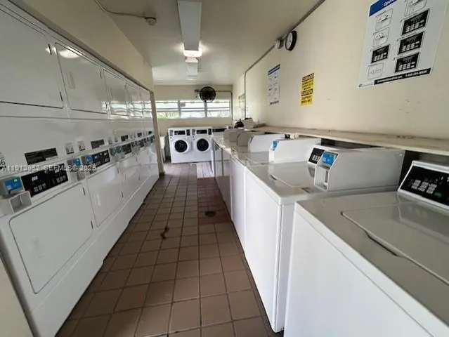 a kitchen with a sink a counter top space cabinets and stainless steel appliances