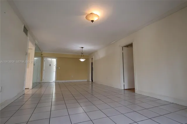 an empty room with fan and entrance