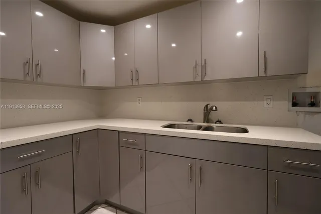 a kitchen with a sink and cabinets