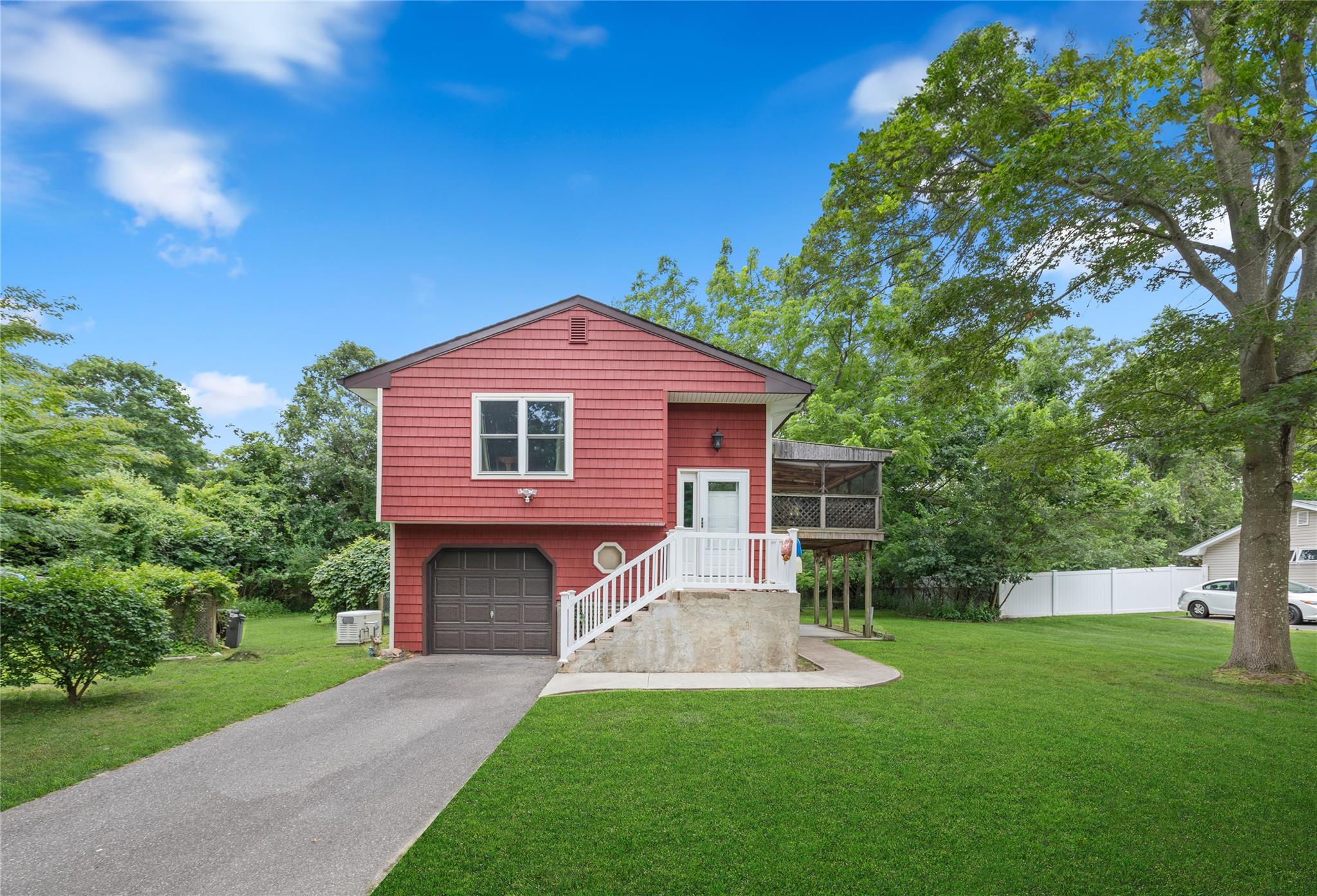 12 Golf Course Road Bellport, NY 11713 - Photo 1 of 1 a front view of a house with a garden and yard