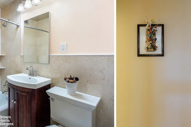 a bathroom with a sink mirror and toilet