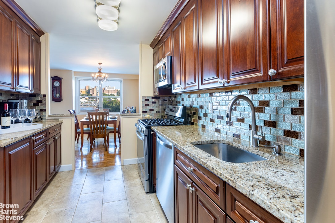 2500 Johnson Avenue, Unit 9P Bronx, NY 10463 - Photo 6 of 21 a kitchen with stainless steel appliances granite countertop a sink stove and cabinets
