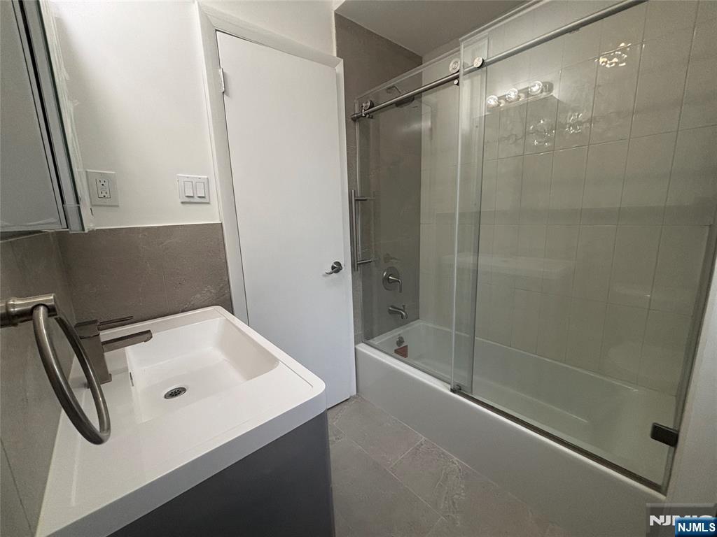 34 Warman Street, Unit 2 Montclair, NJ 07042 - Photo 6 of 11 a bathroom with a shower sink and tub