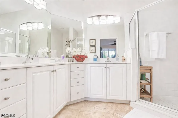 a bathroom with a double vanity sink mirror and