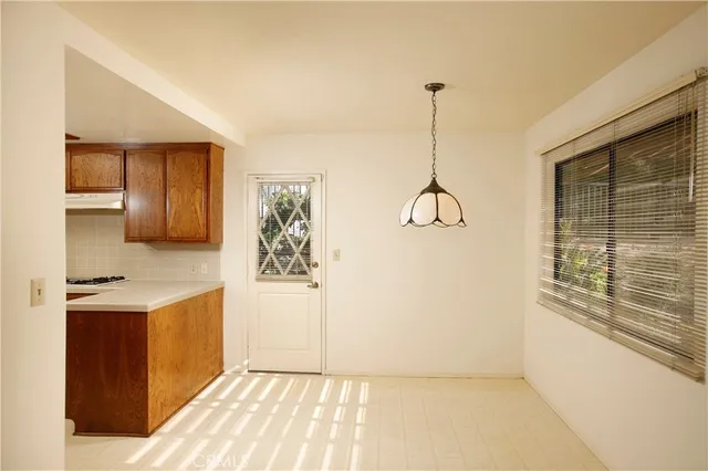 a kitchen with kitchen island a counter top space wooden floor and a window