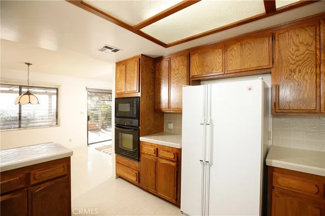 a kitchen with stainless steel appliances a refrigerator and cabinets