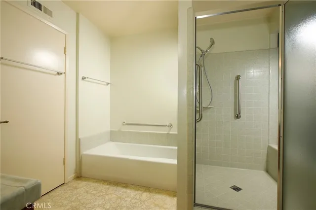 a bathroom with a bathtub shower and toilet