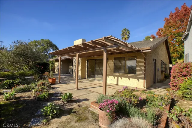 a view of a house with a flower garden
