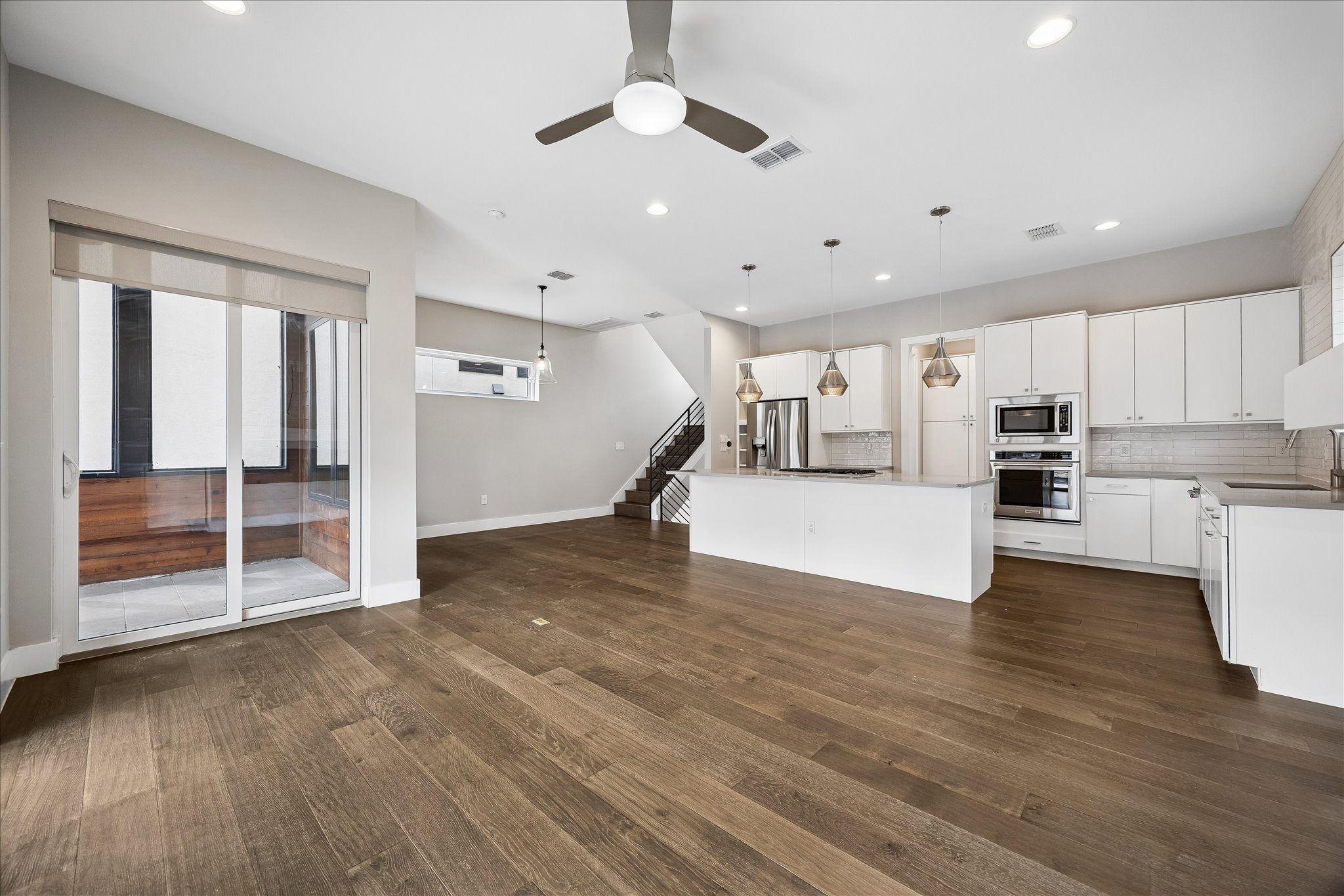 5006 Pecan Springs Road, Unit 6 Austin, TX 78723 - Photo 8 of 30 An open concept living area seamlessly connects to a modern kitchen, featuring sleek stainless steel appliances.