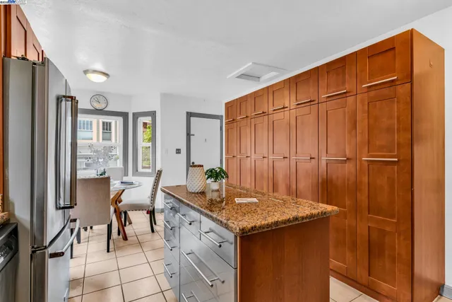 a kitchen with stainless steel appliances granite countertop a refrigerator stove and a sink