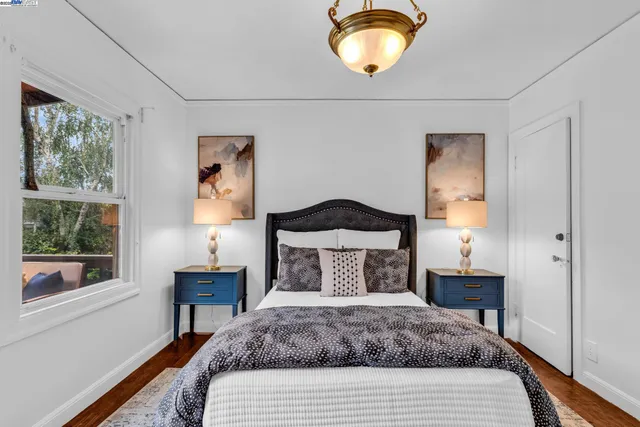 a bedroom with bed and a chandelier