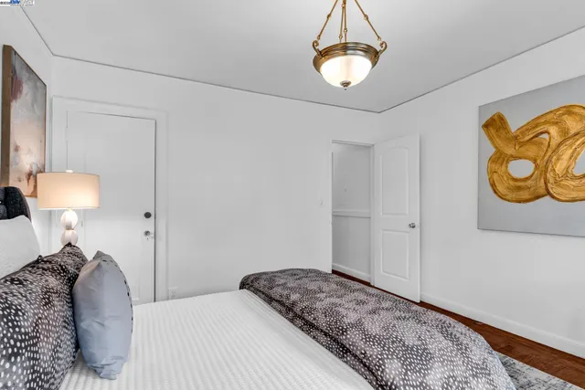 a bathroom with a granite countertop toilet sink and mirror