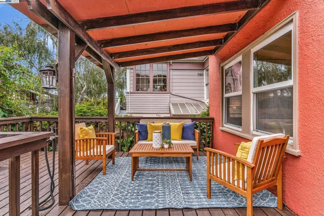 a balcony with wooden floor and furniture