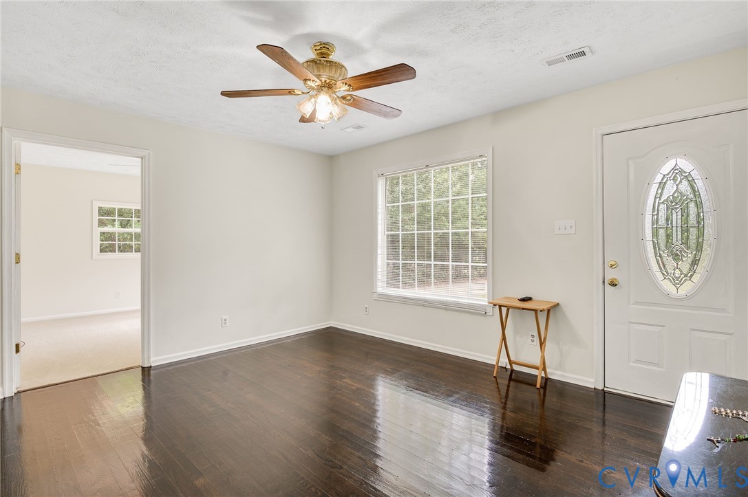 2876 Doctors Road Louisa, VA 23093 - Photo 5 of 36 an empty room with wooden floor mirror and windows