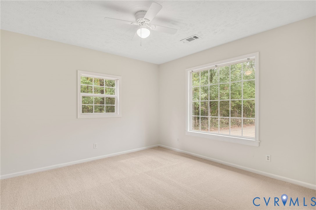 2876 Doctors Road Louisa, VA 23093 - Photo 7 of 36 an empty room with a window and a ceiling fan