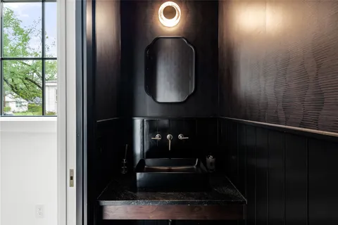a bathroom with a light fixture and a sink
