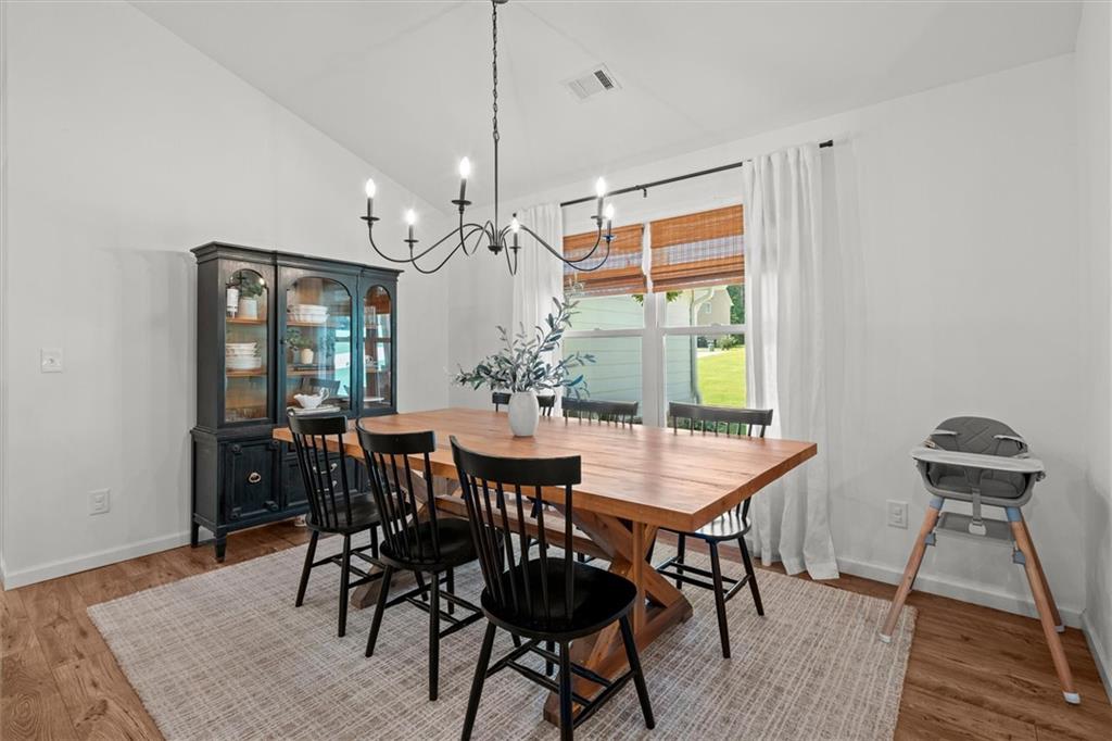 167 Lawrence Drive Villa Rica, GA 30180 - Photo 13 of 43 a view of a dining room with furniture window and wooden floor