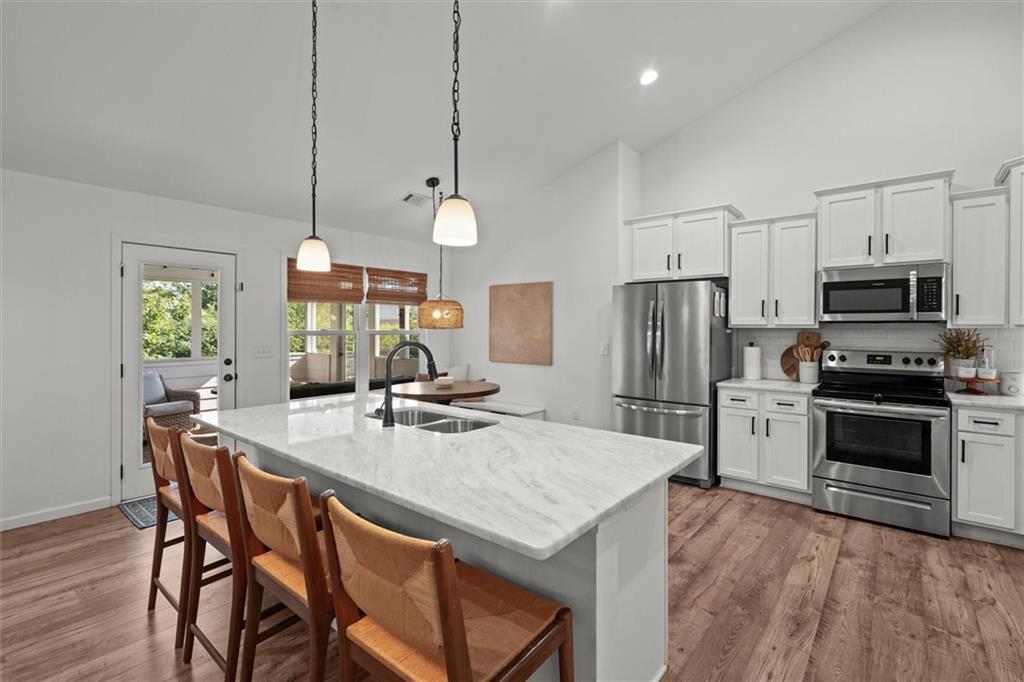 167 Lawrence Drive Villa Rica, GA 30180 - Photo 16 of 43 a kitchen with refrigerator cabinets dining table and chairs