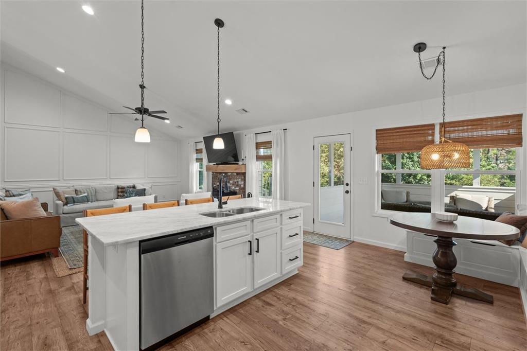 167 Lawrence Drive Villa Rica, GA 30180 - Photo 18 of 43 a view of a kitchen with kitchen island a stove a sink a dining table chairs and wooden floor