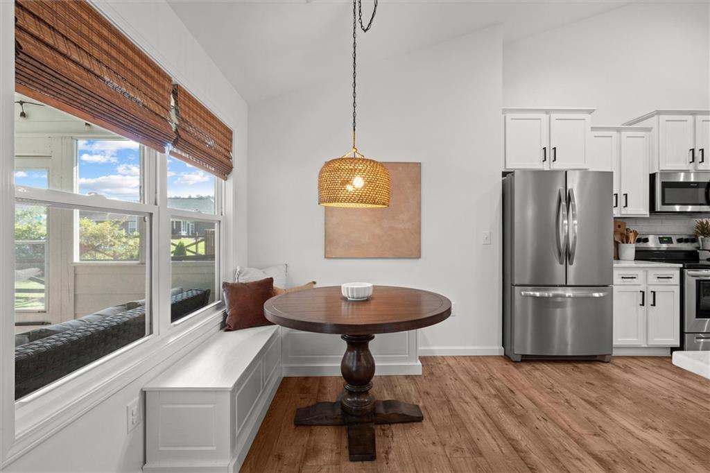 167 Lawrence Drive Villa Rica, GA 30180 - Photo 20 of 43 a kitchen with stainless steel appliances a refrigerator a sink a stove a dining table and chairs
