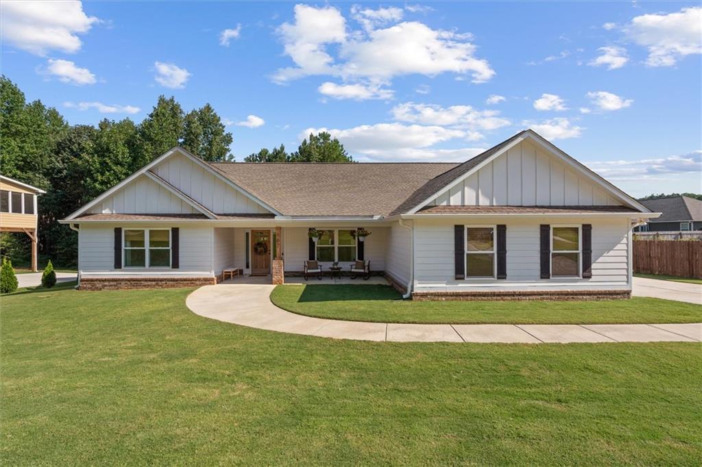 167 Lawrence Drive Villa Rica, GA 30180 - Photo 2 of 43 a front view of a house with a yard garage and outdoor seating