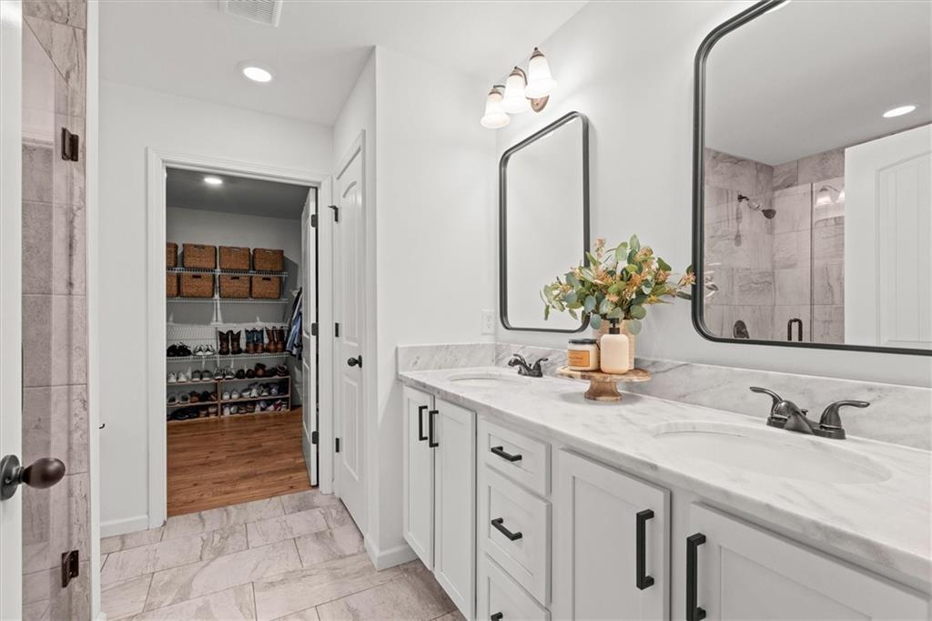 167 Lawrence Drive Villa Rica, GA 30180 - Photo 23 of 43 a bathroom with double vanity sinks and a mirror
