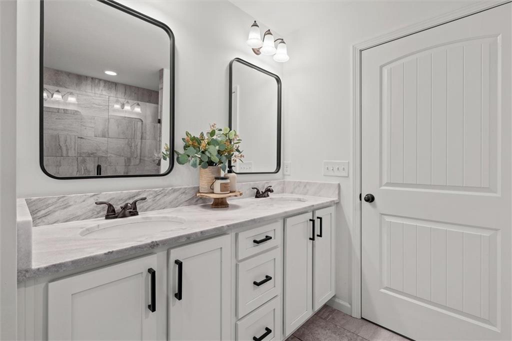 167 Lawrence Drive Villa Rica, GA 30180 - Photo 24 of 43 a bathroom with a double vanity sink and a mirror