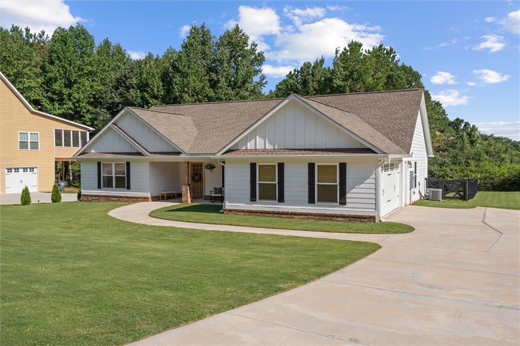167 Lawrence Drive Villa Rica, GA 30180 - Photo 3 of 43 a front view of a house with a garden and porch