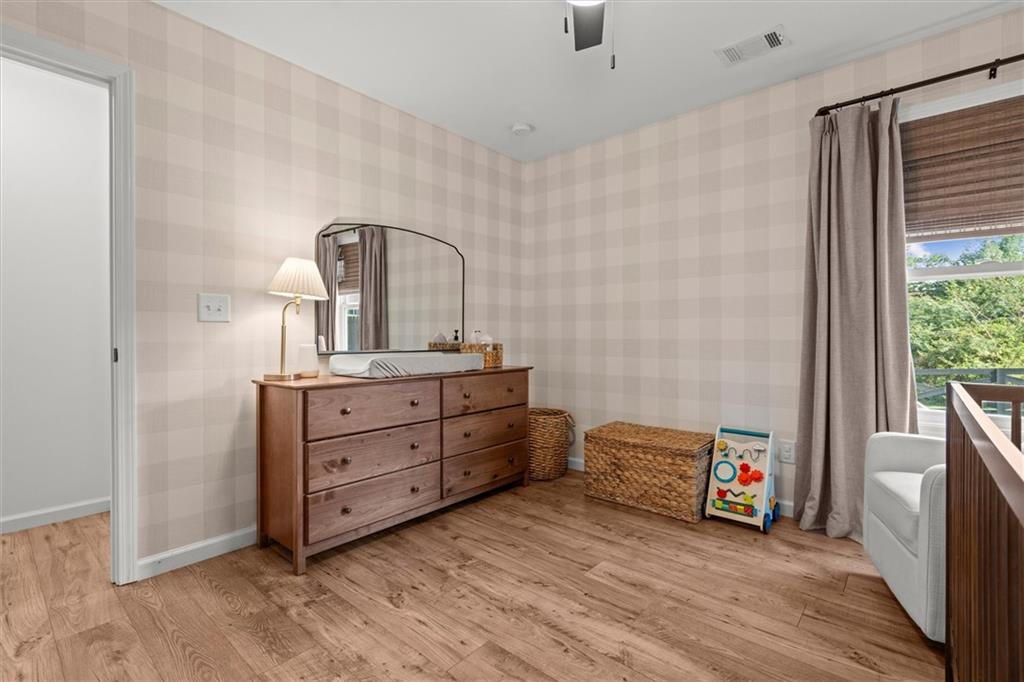 167 Lawrence Drive Villa Rica, GA 30180 - Photo 32 of 43 a bedroom with a bed and a dresser in it