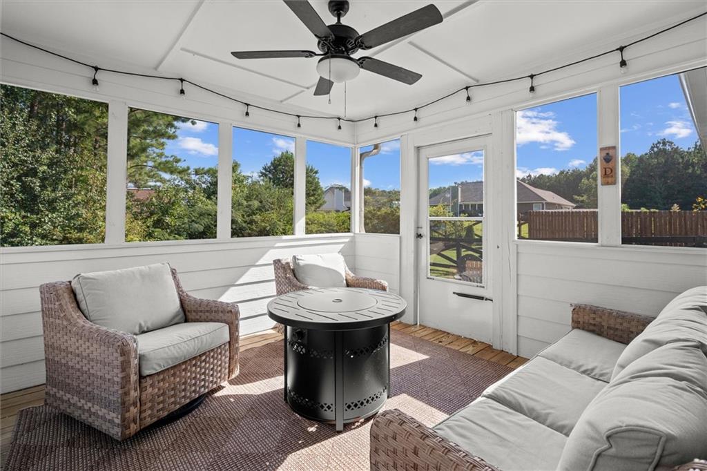167 Lawrence Drive Villa Rica, GA 30180 - Photo 34 of 43 a living room with furniture a ceiling fan and a chandelier