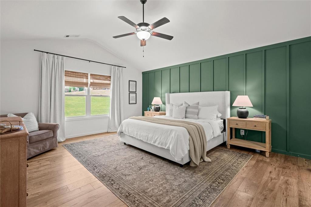 167 Lawrence Drive Villa Rica, GA 30180 - Photo 7 of 43 a bedroom with a bed chandelier and a window