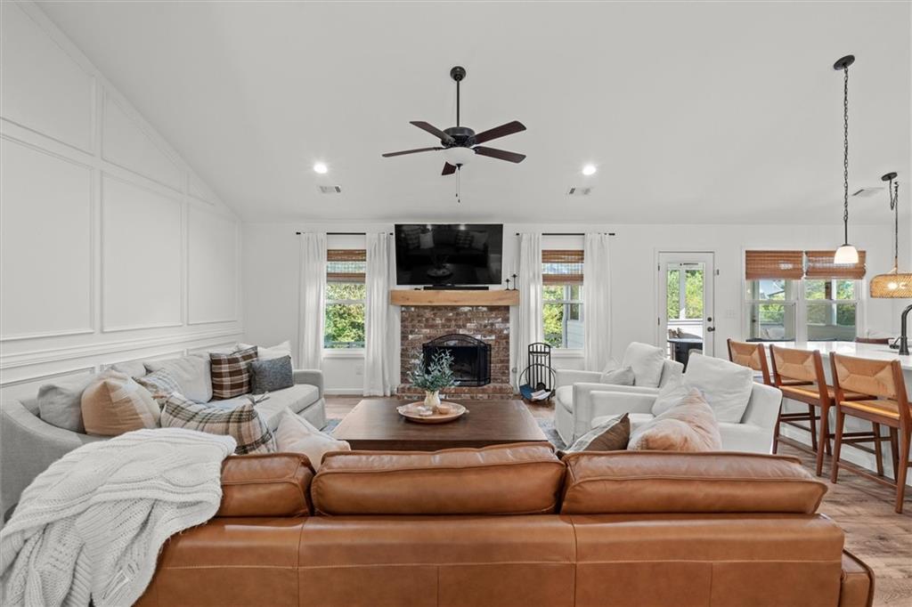 167 Lawrence Drive Villa Rica, GA 30180 - Photo 9 of 43 a living room with furniture a fireplace and a flat screen tv