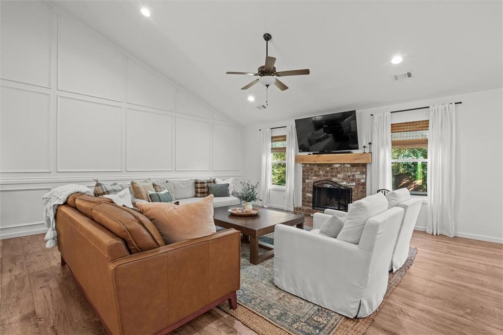 167 Lawrence Drive Villa Rica, GA 30180 - Photo 10 of 43 a living room with furniture a flat screen tv and a fireplace