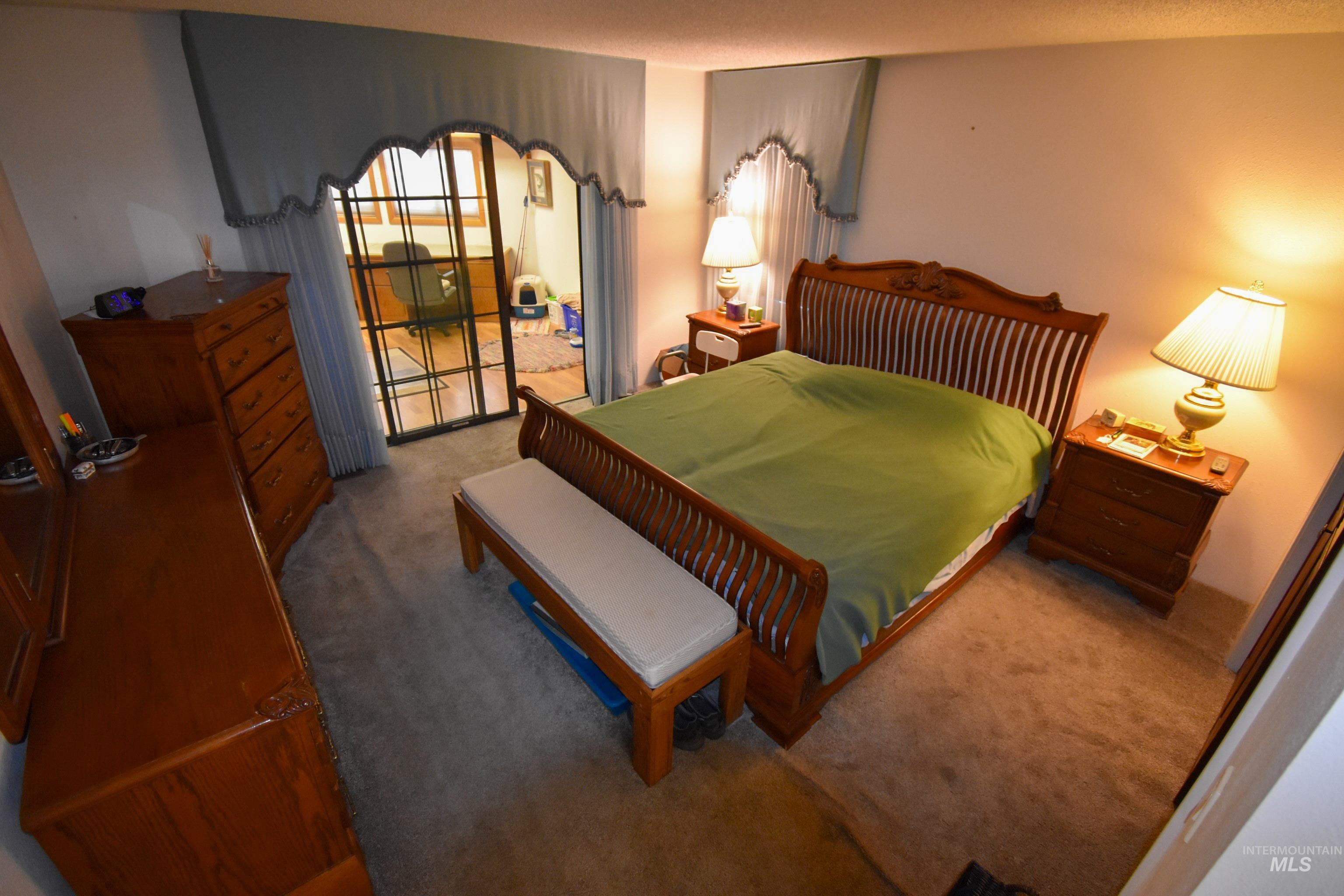 209 Harding Street Asotin, WA 99402 - Photo 13 of 29 Carpeted bedroom featuring arched walkways