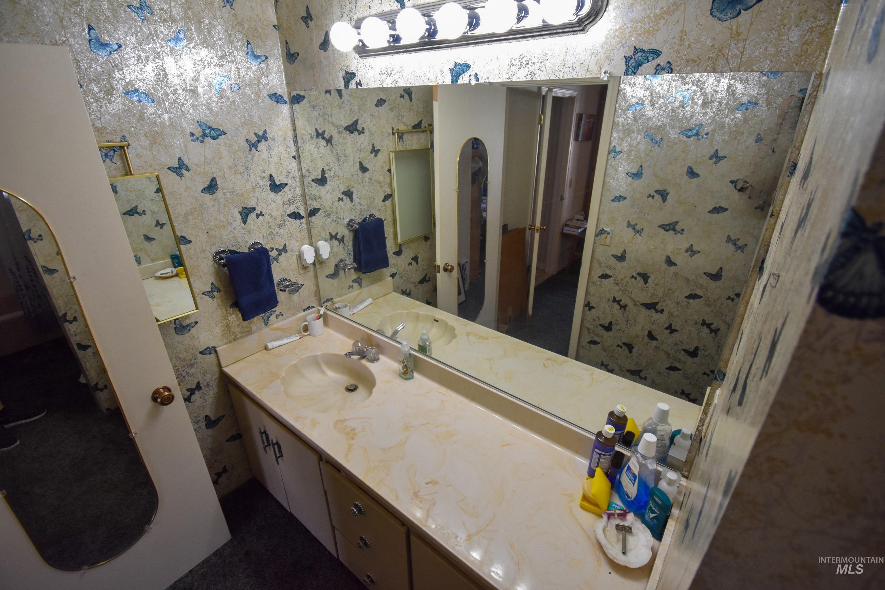 209 Harding Street Asotin, WA 99402 - Photo 10 of 29 Bathroom with vanity and wallpapered walls