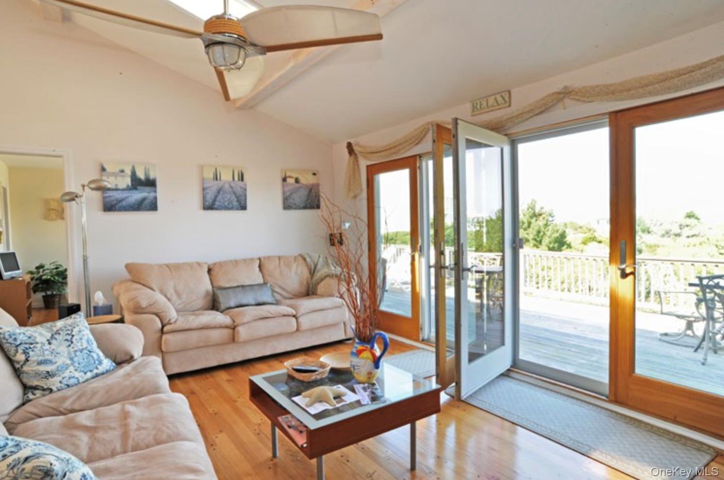 900 Dune Road Westhampton Beach, NY 11978 - Photo 13 of 14 a living room with furniture and a floor to ceiling window