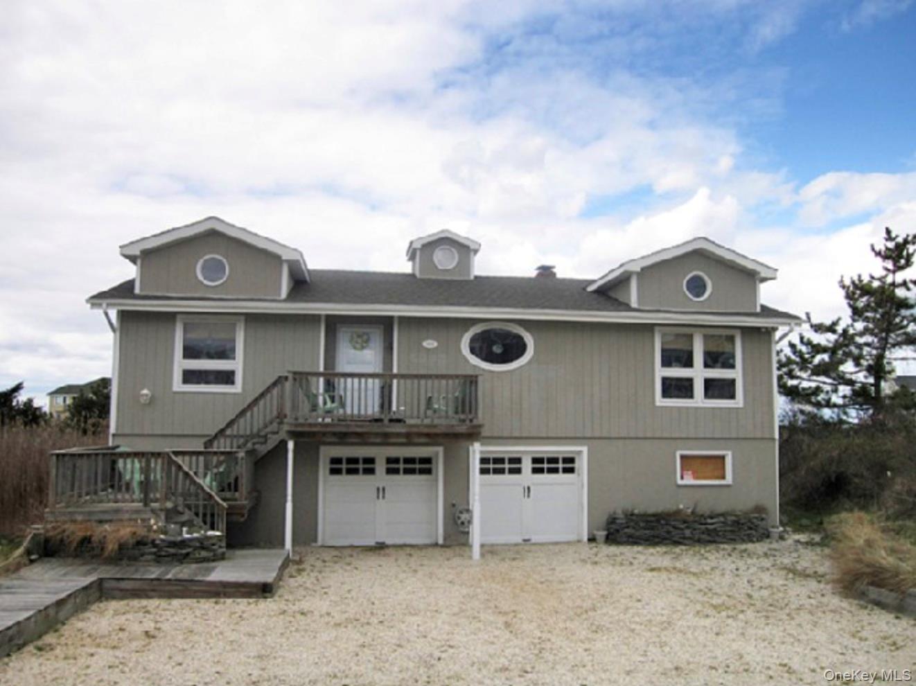 900 Dune Road Westhampton Beach, NY 11978 - Photo 2 of 14 a front view of a house with a yard
