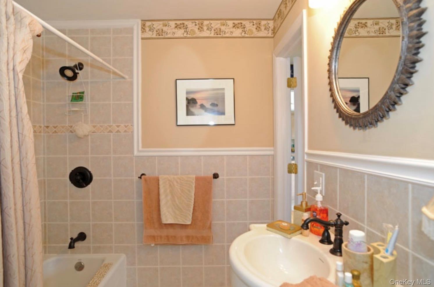 900 Dune Road Westhampton Beach, NY 11978 - Photo 5 of 14 a bathroom with a sink a mirror and a shower curtain
