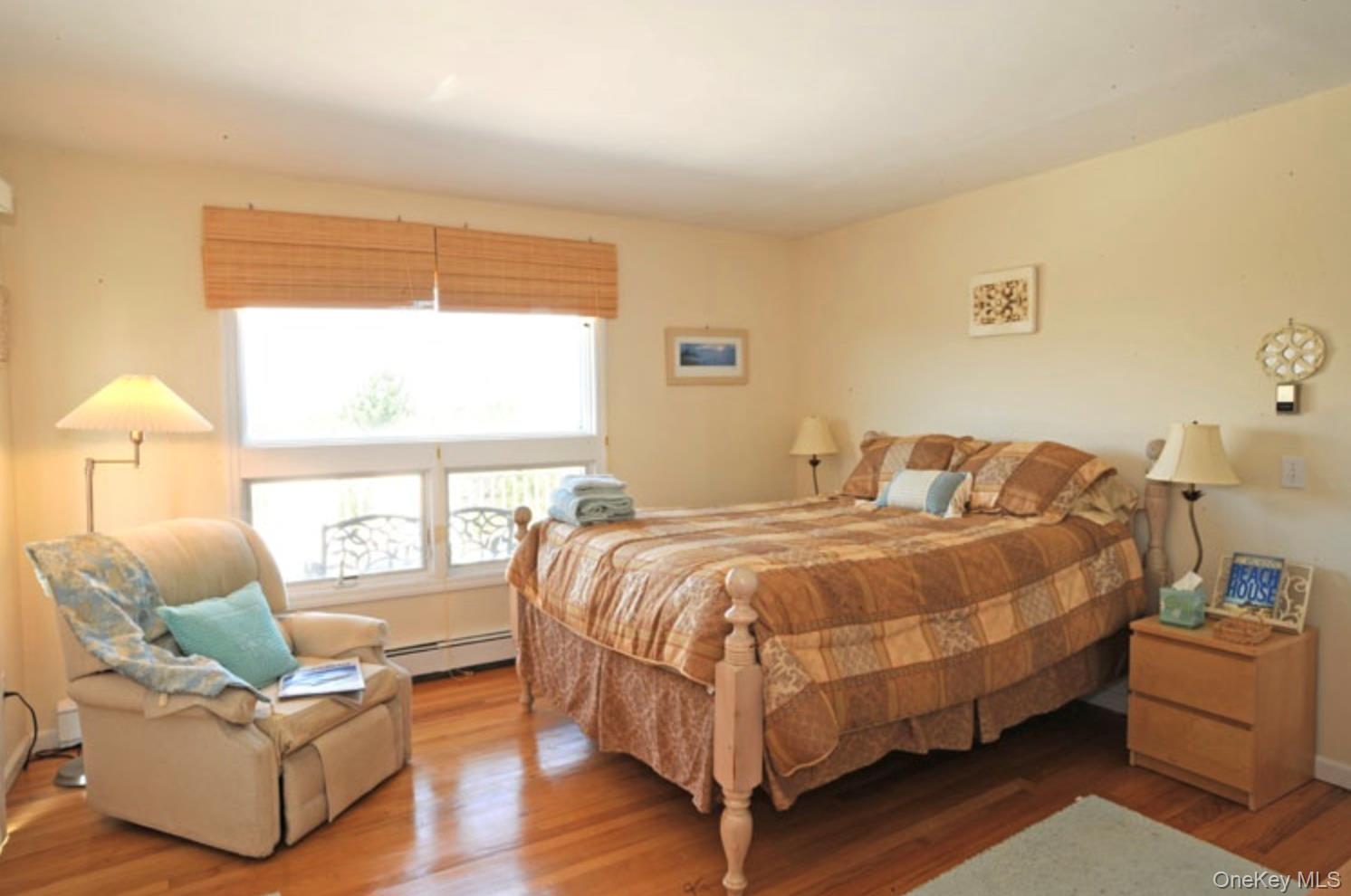 900 Dune Road Westhampton Beach, NY 11978 - Photo 9 of 14 a bedroom with a bed and wooden floor