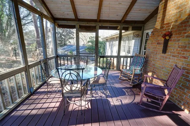 a view of a dining room with furniture wooden floor and a potted plant