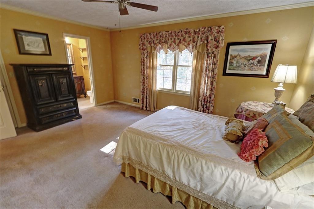 253 Newport Road Southwest Lilburn, GA 30047 - Photo 16 of 40 a bedroom with a bed and a window